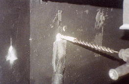 1.17 - Drilling holes for the moving arm at Los Leones bay 4-5. The
  vacuum cleaner is used to avoid dust